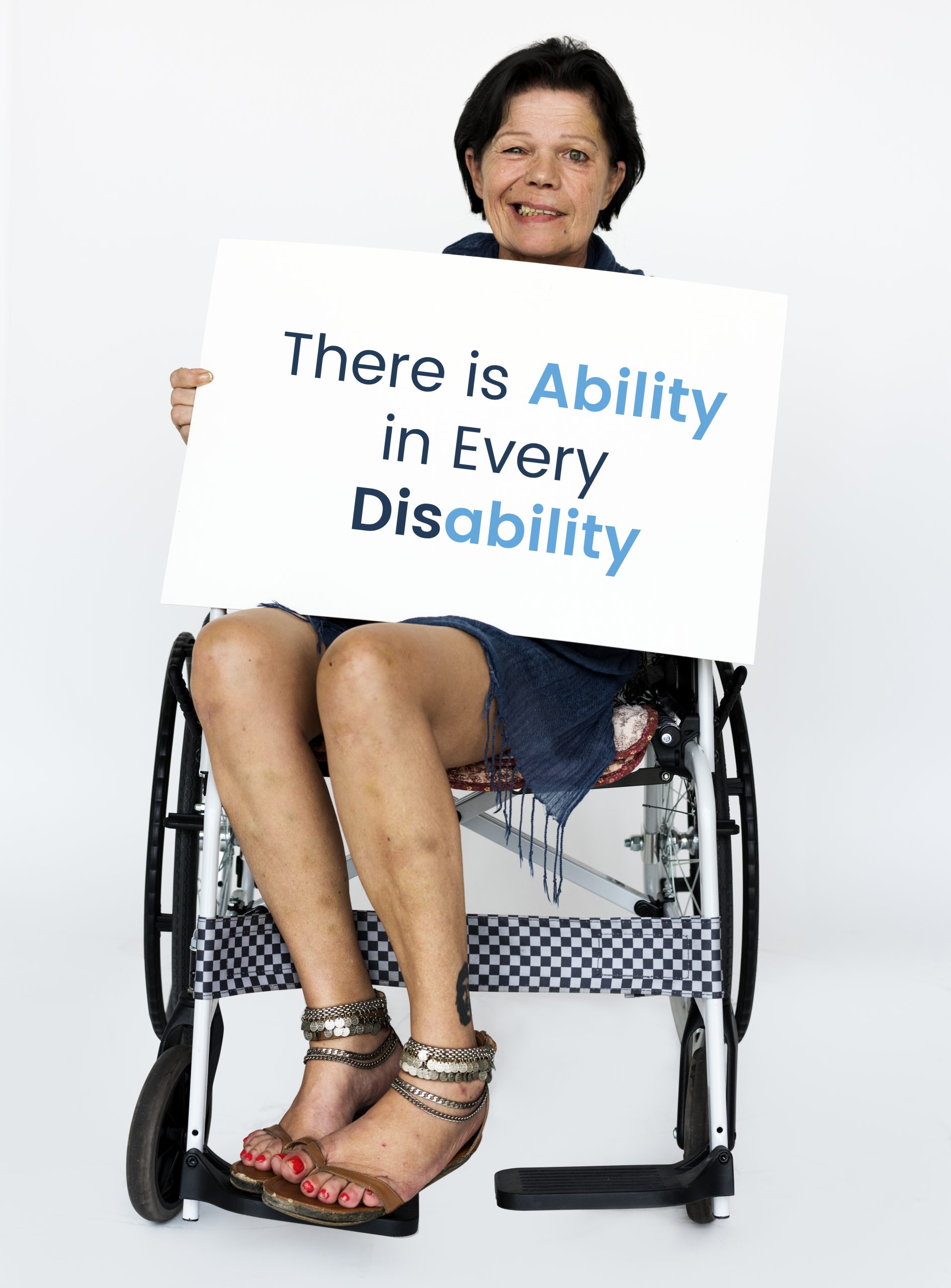 There is Ability in Every Disability sign being held by a woman in a wheelchair